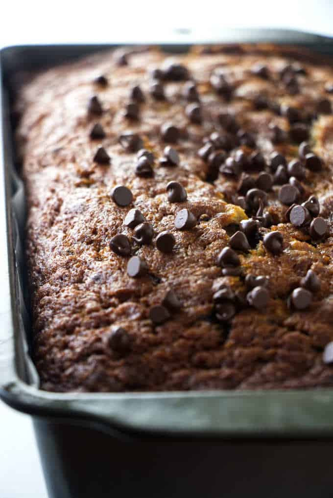 Banana bread fresh out of the oven with chocolate chips on top.