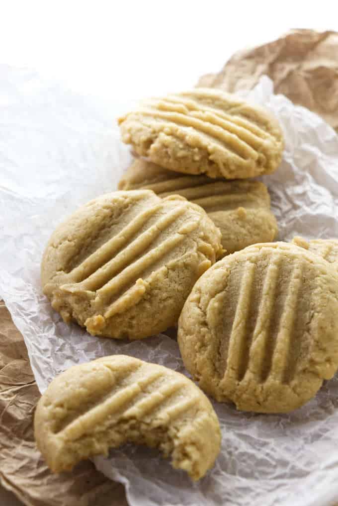 Several tahini cookies on some parchment paper.