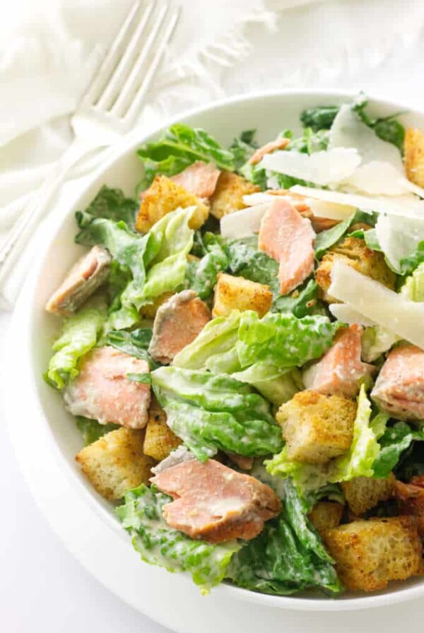 Overhead view of a serving of salad, napkin and fork in background