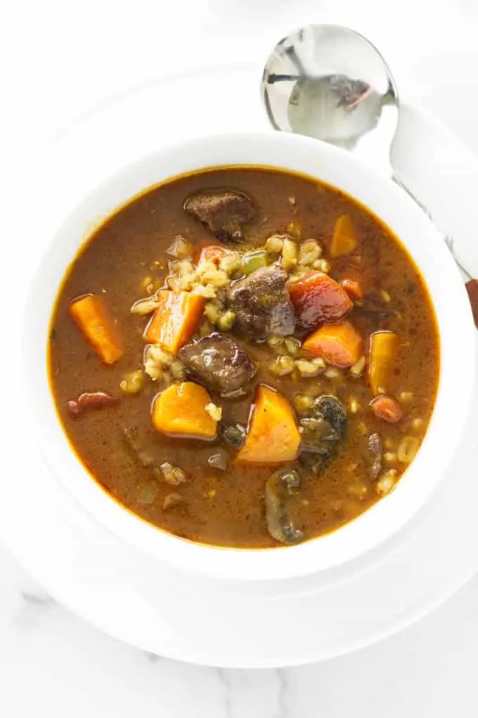 Overhead photo of beef barley soup in a bowl.