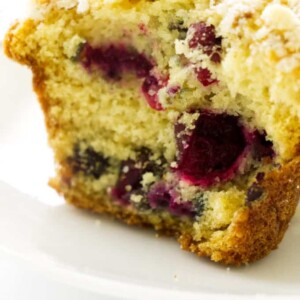 Close up photo of half of a cranberry muffin with walnut streusel topping