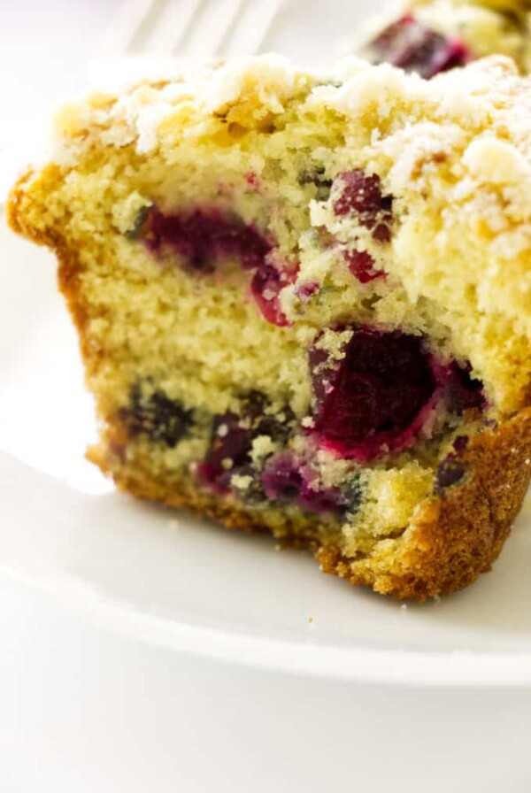 Close up photo of half of a cranberry muffin with walnut streusel topping