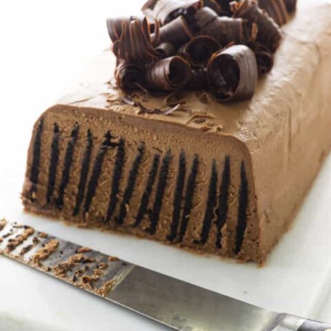 Sliced cake on serving board with knife