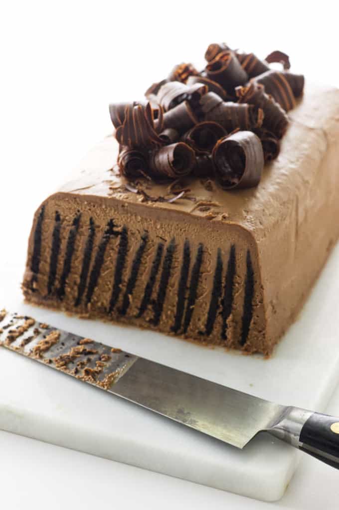 Sliced cake on serving board with knife