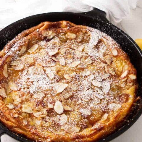 A cherry clafoutis baked in a cast iron skillet.