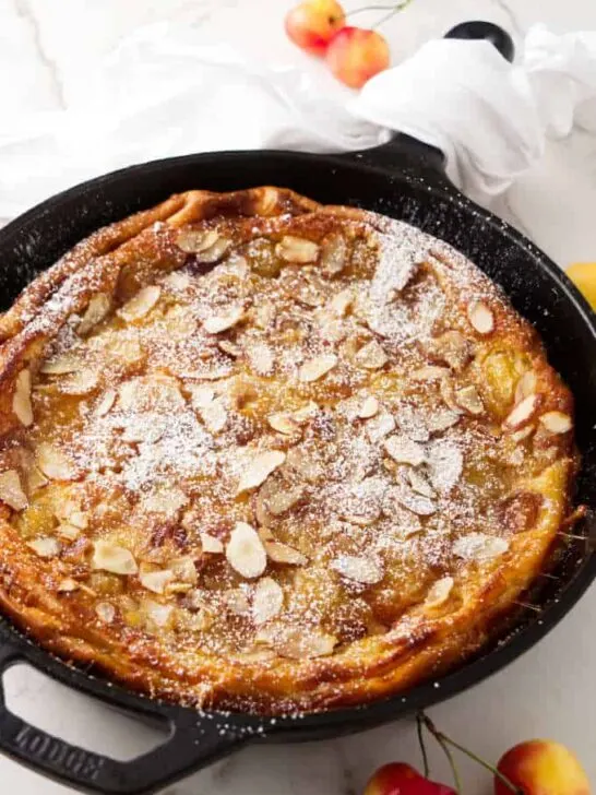 A cherry clafoutis baked in a cast iron skillet.