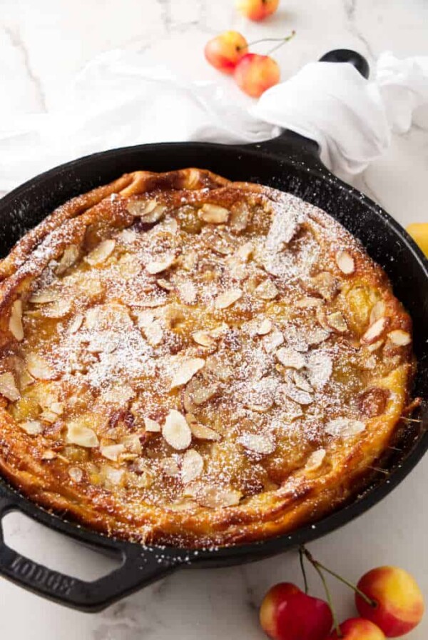 A cherry clafoutis baked in a cast iron skillet.