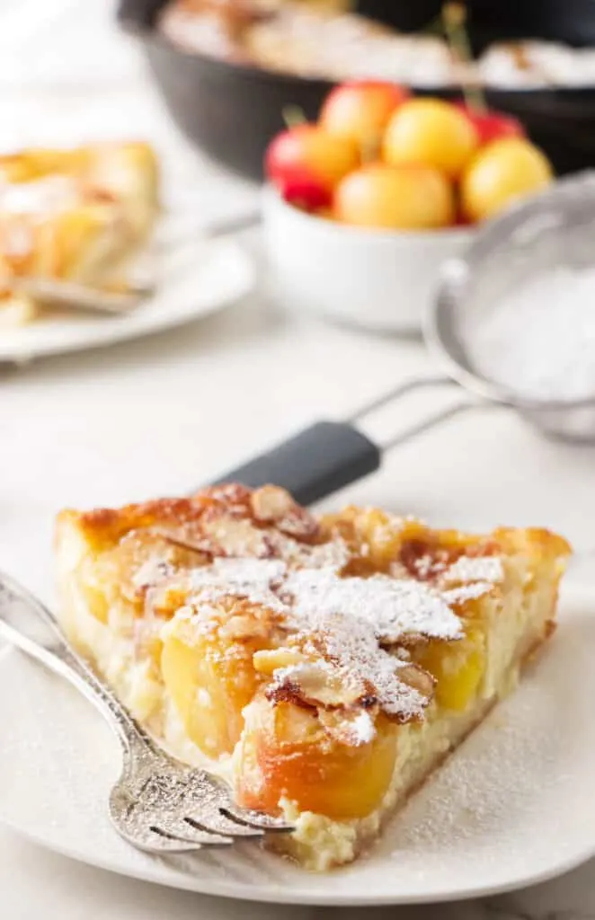 A slice of cherry clafoutis on a plate.