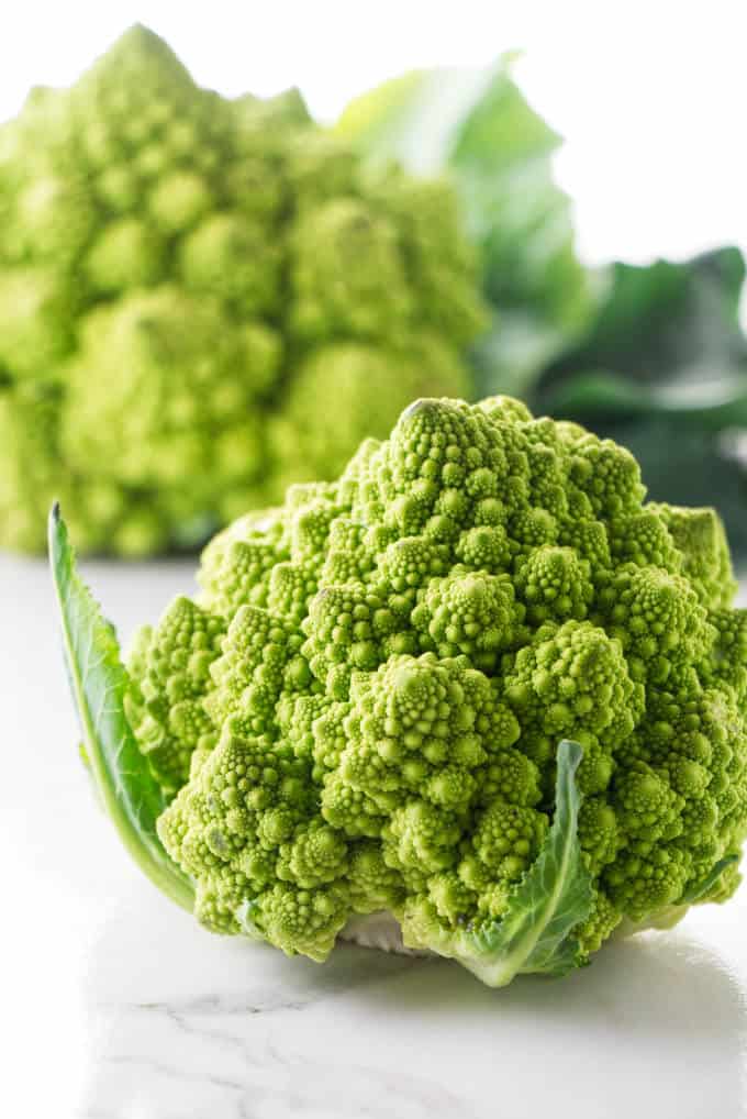 A photo of two heads of fresh romanesco.