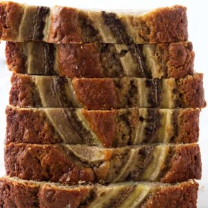 Slices of sourdough banana bread stacked on top of each other.