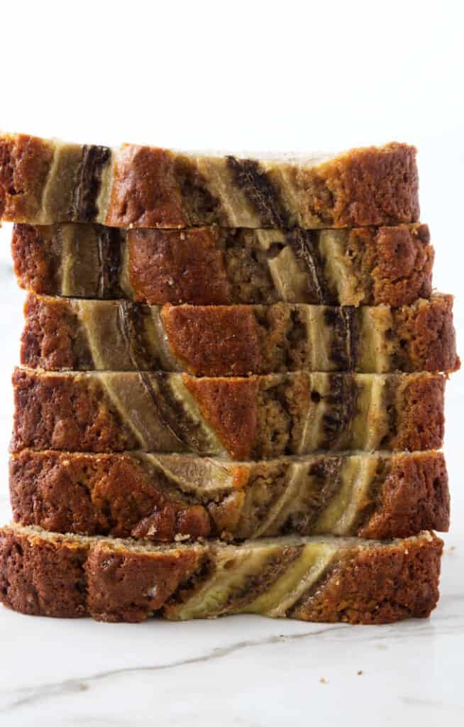Slices of sourdough banana bread stacked on top of each other.