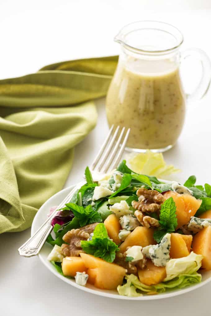 Cantaloupe and blue cheese salad with dressing on the side.