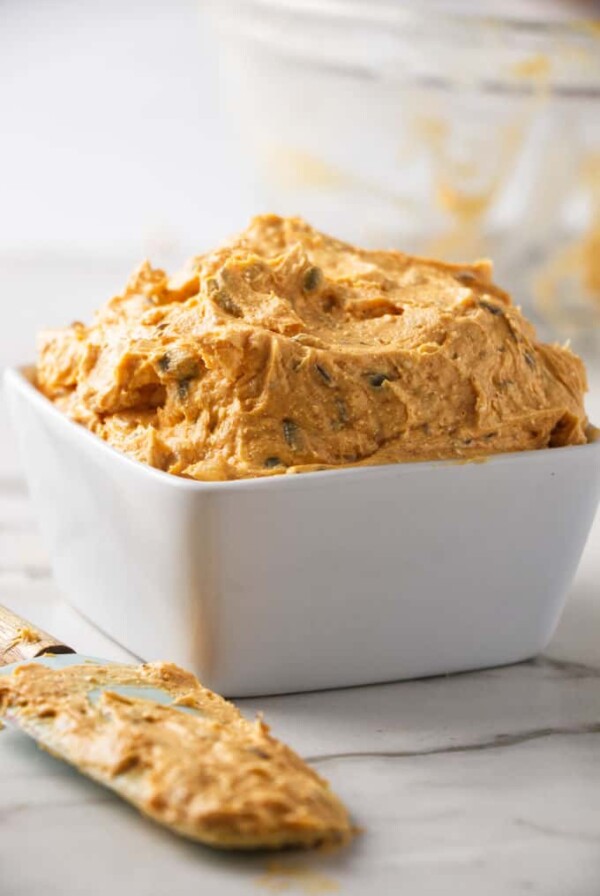 A dish of Liptauer cheese spread with a spatula next to it.