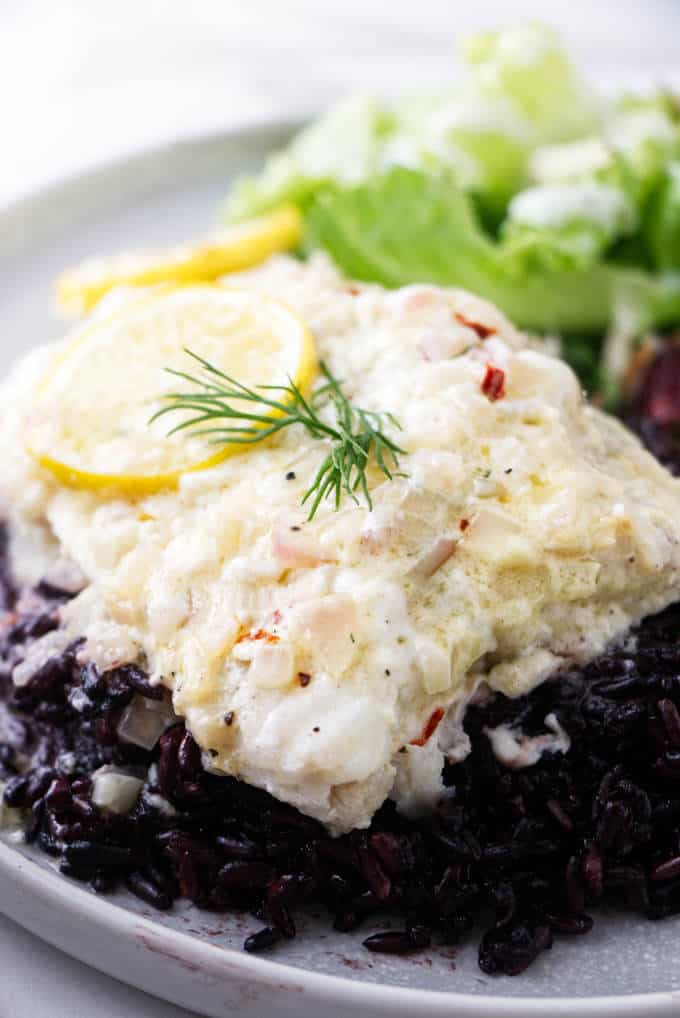 Baked wolffish on a bed of black rice.