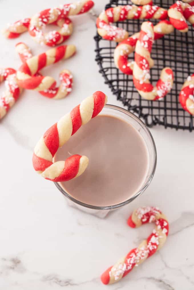 Candy cane cookies with a glass of chocolate milk.