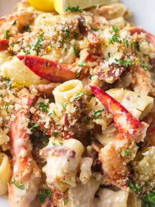 Closeup of lobster pasta with creamy garlic sauce.