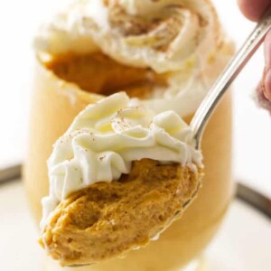 A spoon with a scoop of pumpkin mousse.