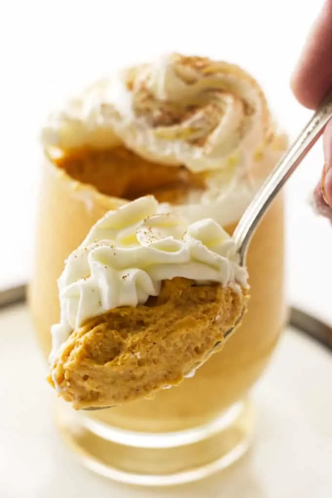 A spoon with a scoop of pumpkin mousse.