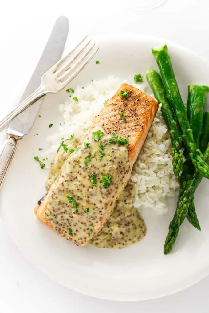 Salmon with creamy mustard sauce on a bed of rice.
