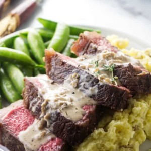 Bison ribeye steak on a bed of mashed potatoes.