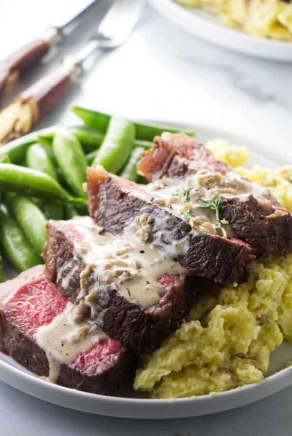 Bison ribeye steak on a bed of mashed potatoes.