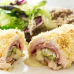 Chicken rolled up with ham, cheese, and asparagus then sliced open to see the inside