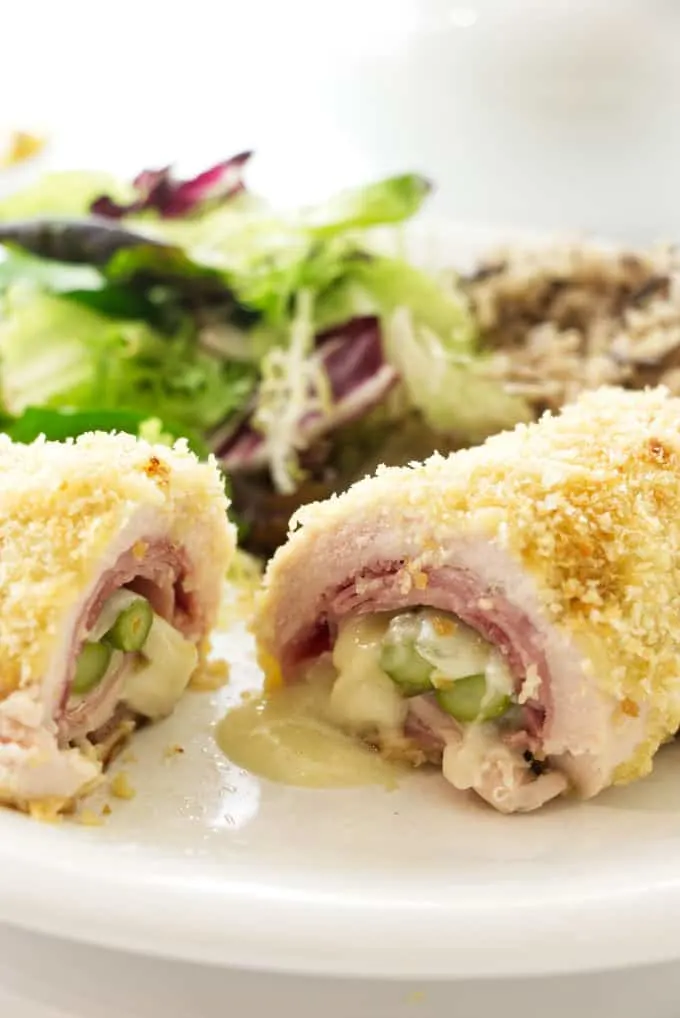 Chicken rolled up with ham, cheese, and asparagus then sliced open to see the inside