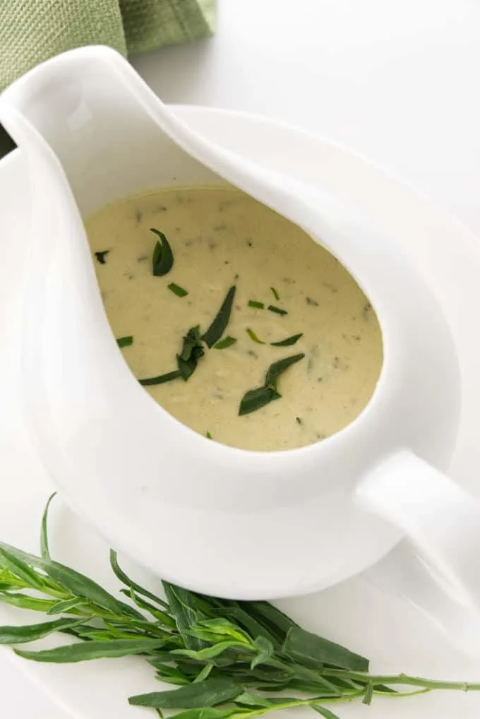 Creamy tarragon sauce in a dish with a spout.