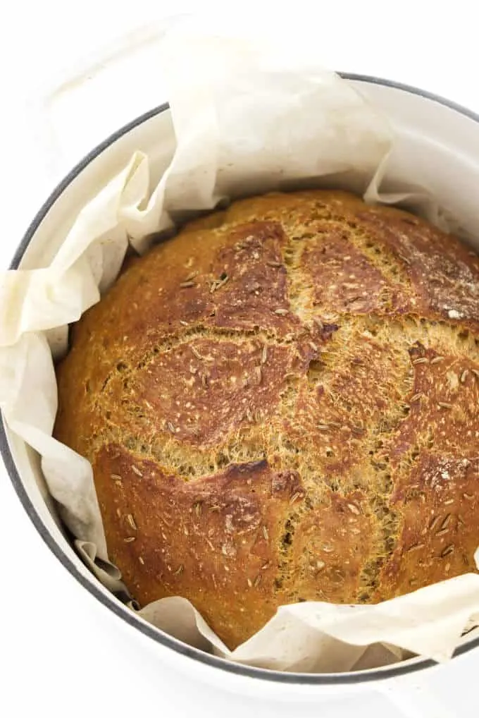 Freshly baked no-knead rye bread in a Dutch oven.