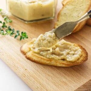 Roasted garlic spread on a piece of toast.