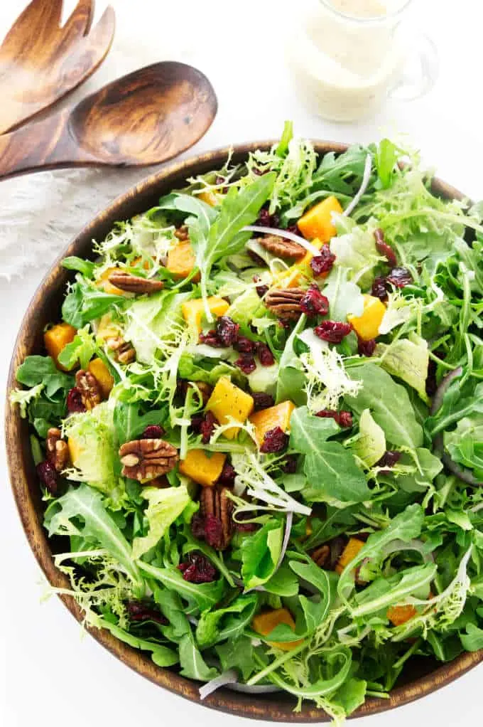 Overhead photo of butternut squash salad with mixed greens.
