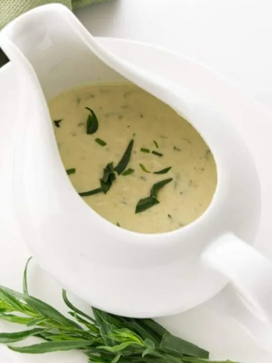 Creamy tarragon sauce in a dish with a spout.