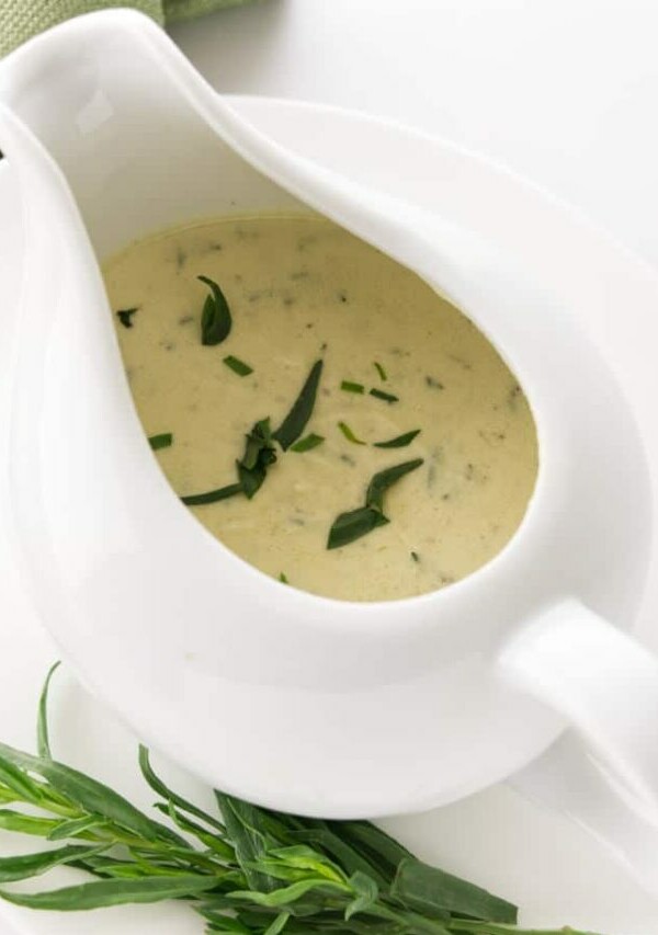 Creamy tarragon sauce in a dish with a spout.