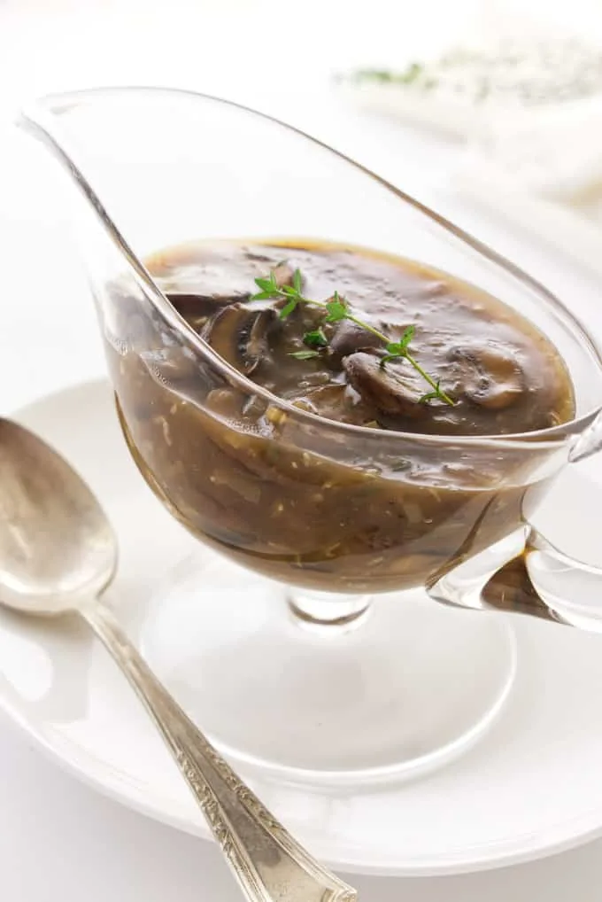 Close up of a dish of white wine mushroom sauce.