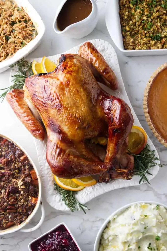 An overhead photo of a full Thanksgiving dinner with turkey and all the sides.