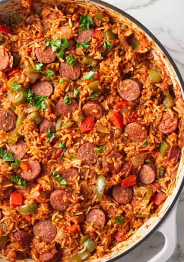 A large skillet filled with a sausage and rice one dish dinner.