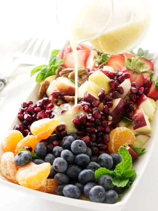 Winter fruit salad with lemon-honey vinaigrette pour