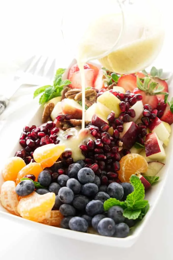 Winter fruit salad with lemon-honey vinaigrette pour