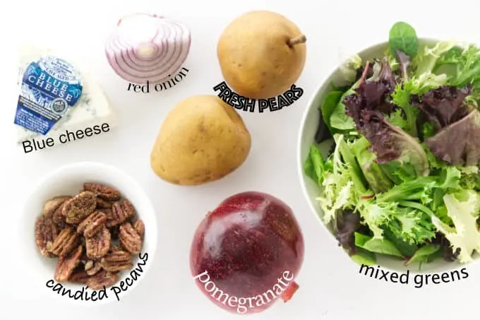 Ingredients needed to make a pomegranate pear salad with blue cheese.