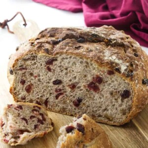 Close up view of a cut loaf of bread and two broken chunks