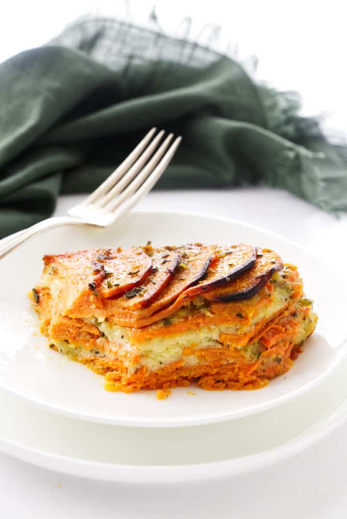 A serving of scalloped sweet potato casserole on a plate.