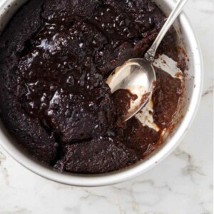 overhead photo of hot fudge cake with a spoon in the center of the cake.