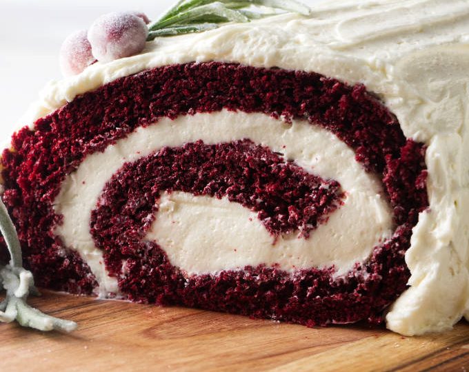 Red velvet cake roll showing the end of the roll with the swirl of cake and ermine frosting filling.