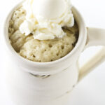 A banana mug cake with ice cream on top.