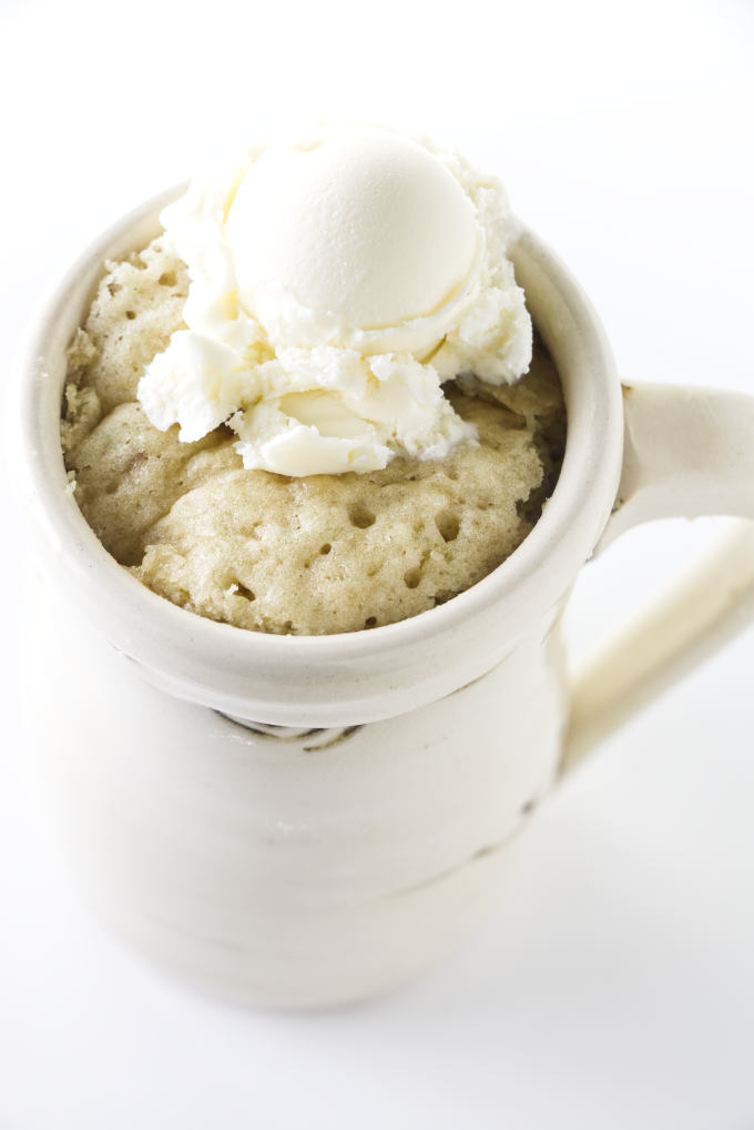 A banana mug cake with ice cream on top.