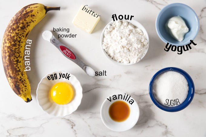 Ingredients needed for banana cake in a mug.