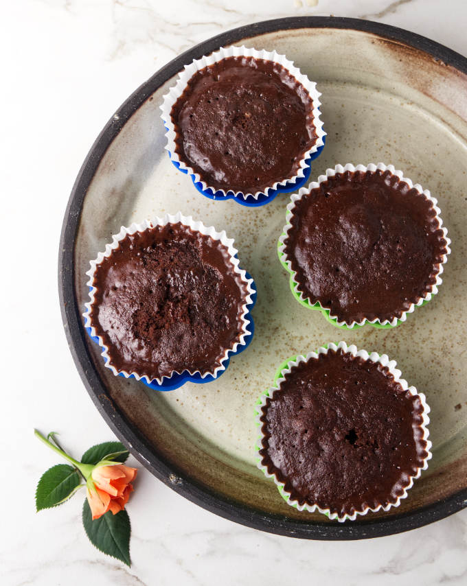 Four cupcakes baked in the microwave from the batter for a chocolate mug cake.