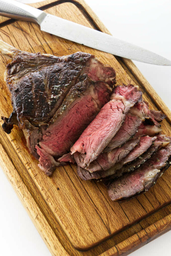 Overhead view of Reverse sear cowboy steak on cutting board