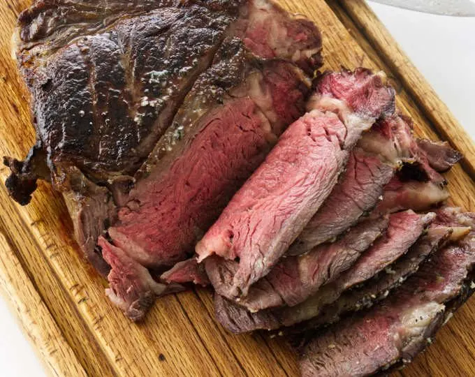 Overhead view of Reverse sear cowboy steak on cutting board