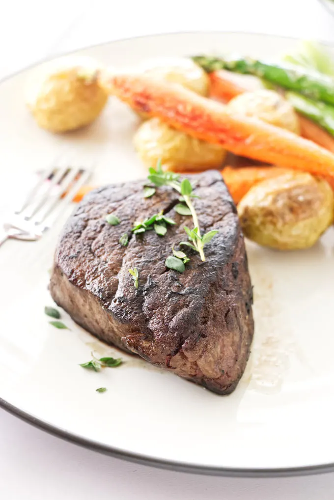 Plated Filet Mignon with roasted potatoes, carrots and asparagus